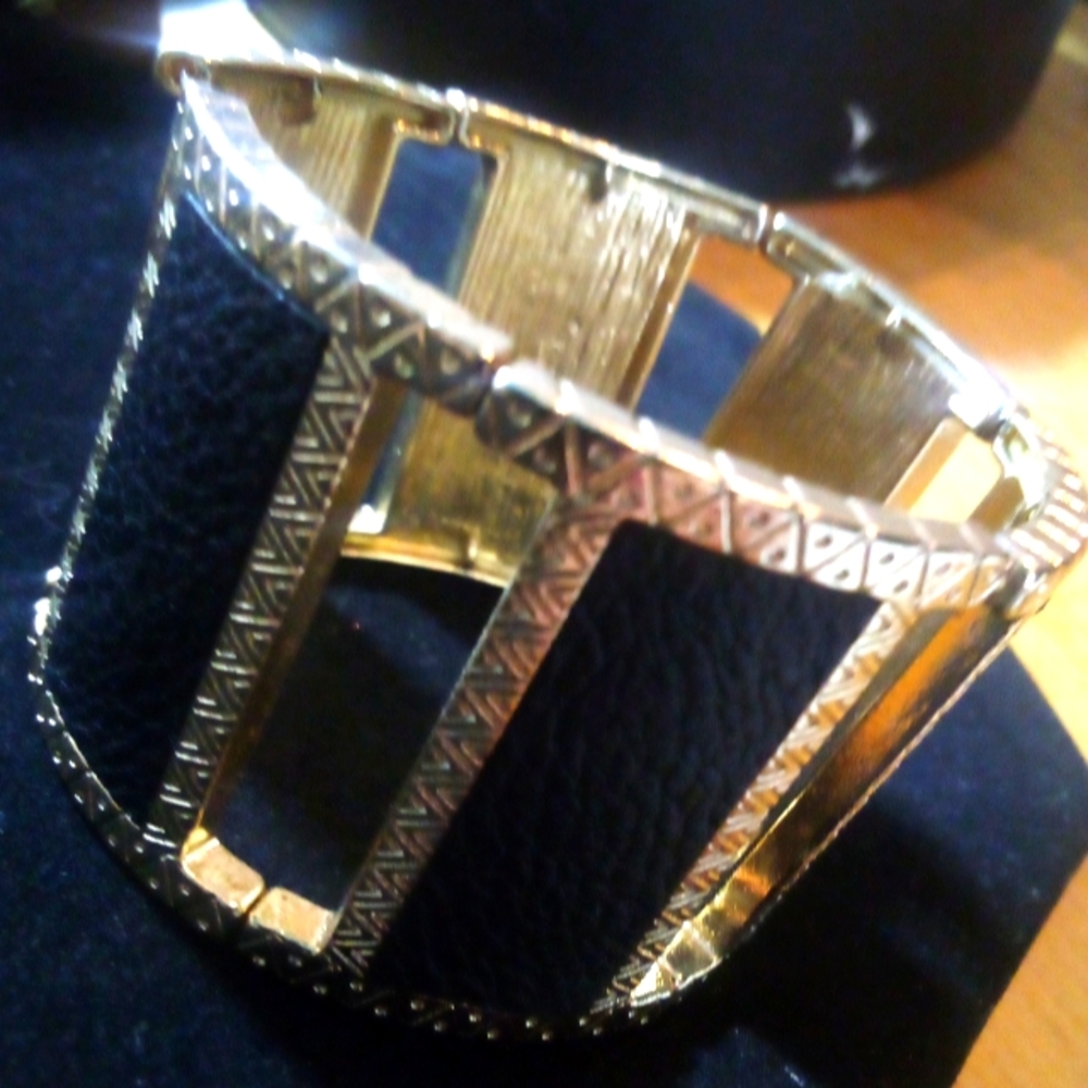 Black leather and Gold metal stretch bangle style bracelet.